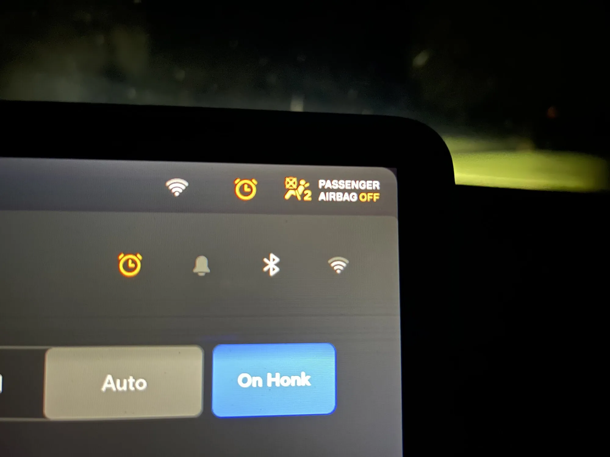 Tesla touchscreen showing alarm and Passenger Airbag Off alerts after programming service