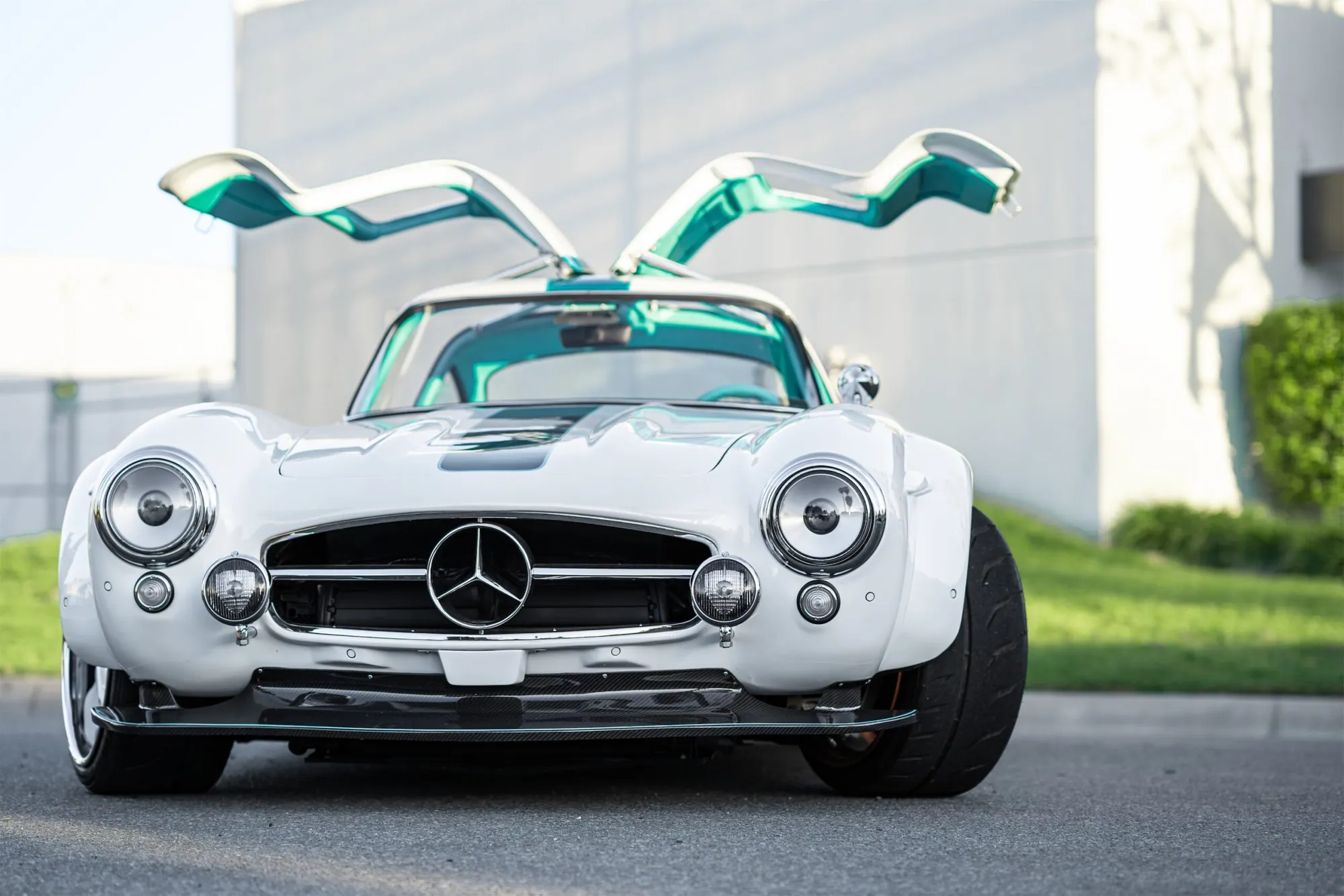 Tesla Gullwing project: white 300SL-style EV with teal interior and gullwing doors open