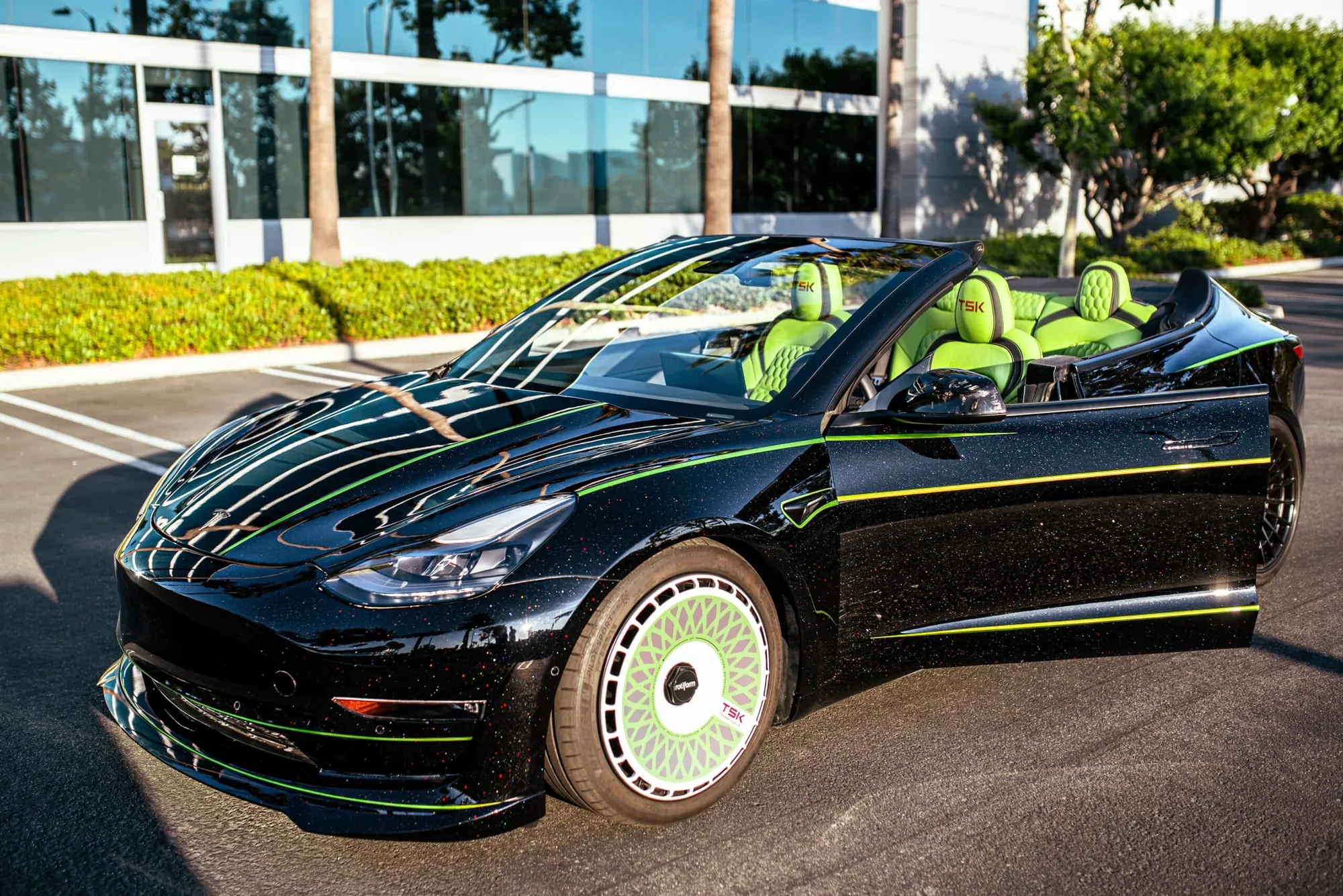 Roofless Tesla project: black Tesla Model 3 with no roof, green interior and green wheel covers